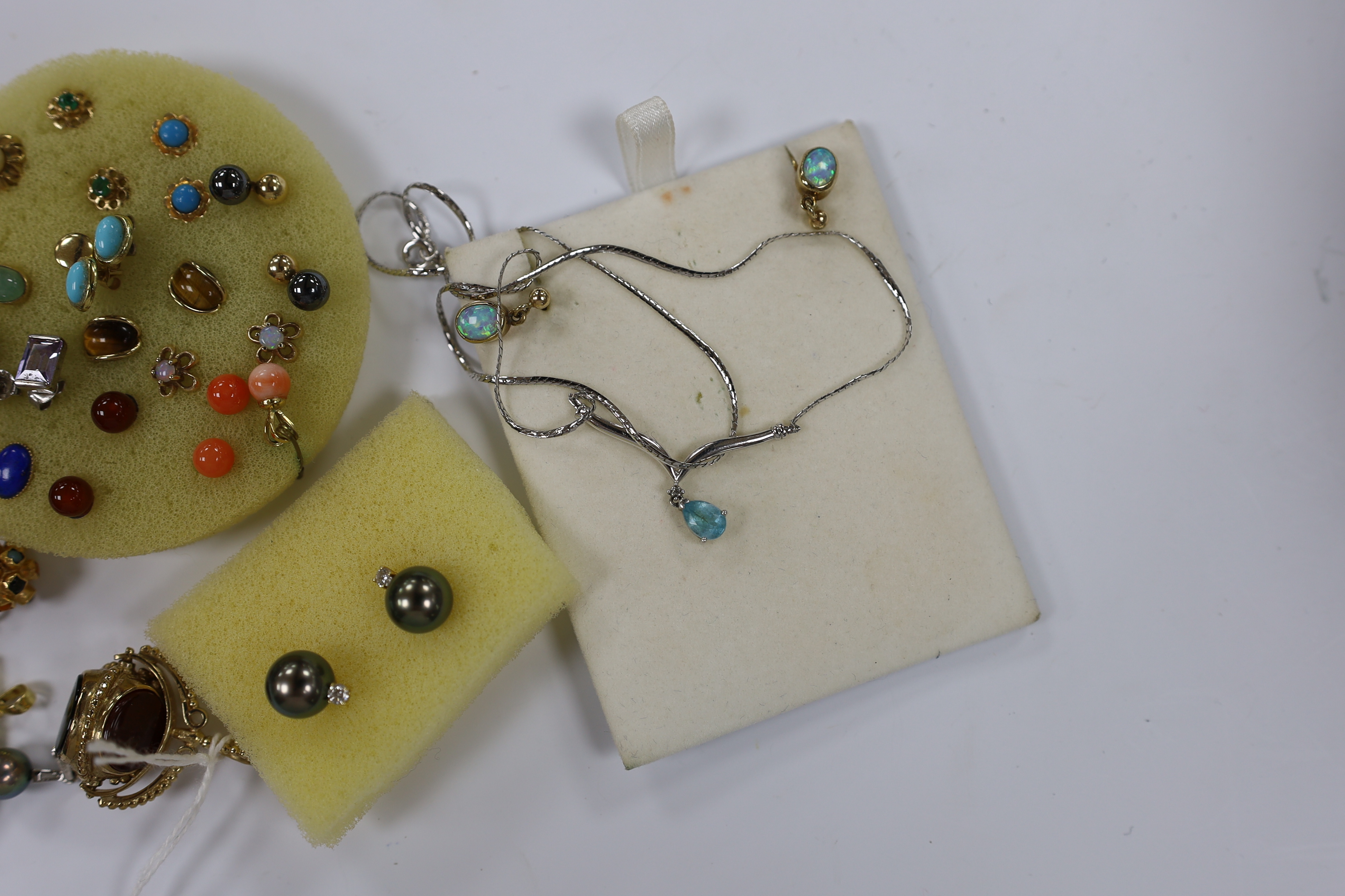 A quantity of mainly modern 9ct gold or yellow metal and gem set jewellery, including earrings, ring, fob seal, pendants, etc. and a pair of 750 Tahitian pearl and diamond set ear studs.